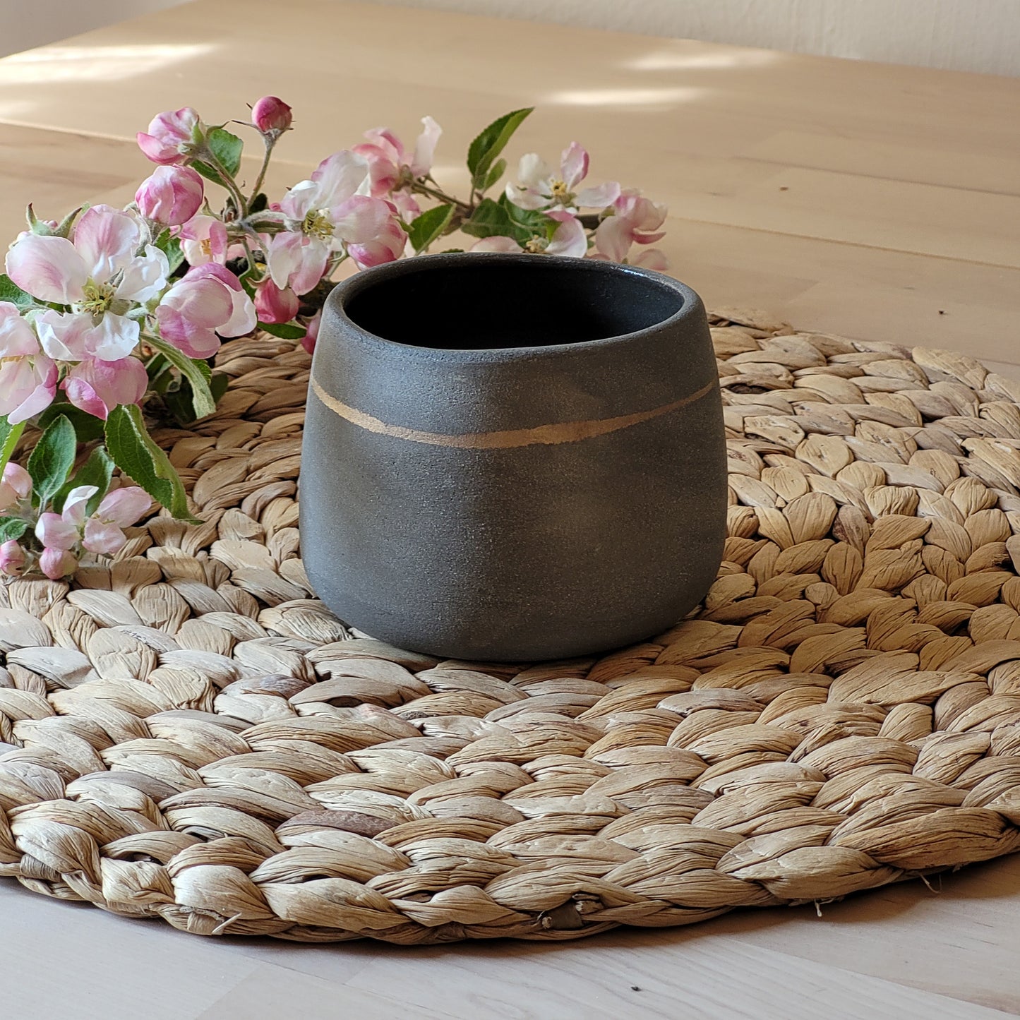 Simple, gray ceramic mug with a gold line. This mug would make an excellent gift.