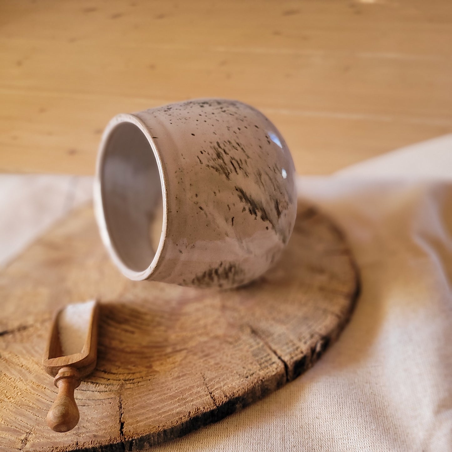 Ceramic salt pig, gray with speckled glaze, and wooden spoon. Handmade.