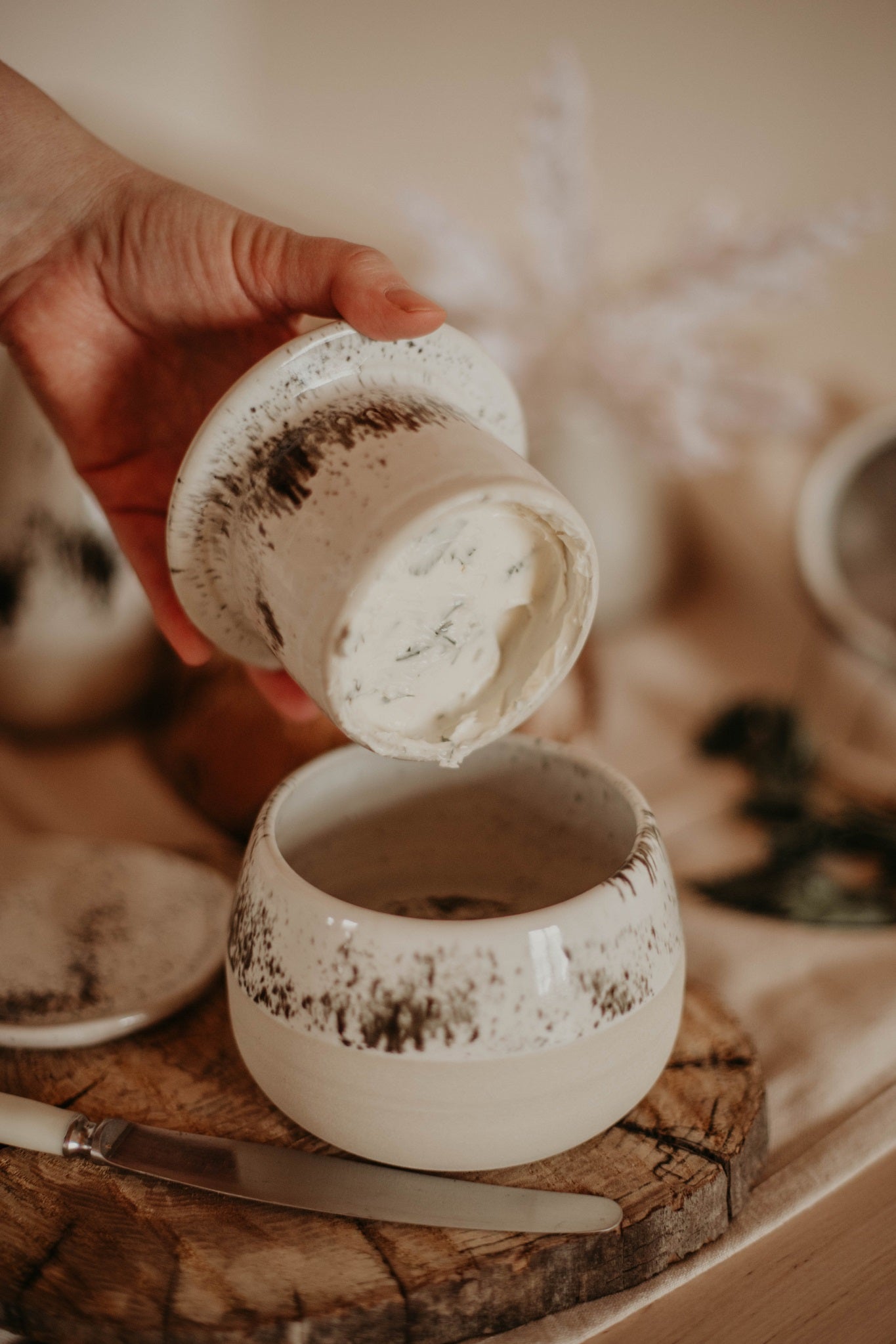 Handmade French-style ceramic butter dish styled in a rustic kitchen setting