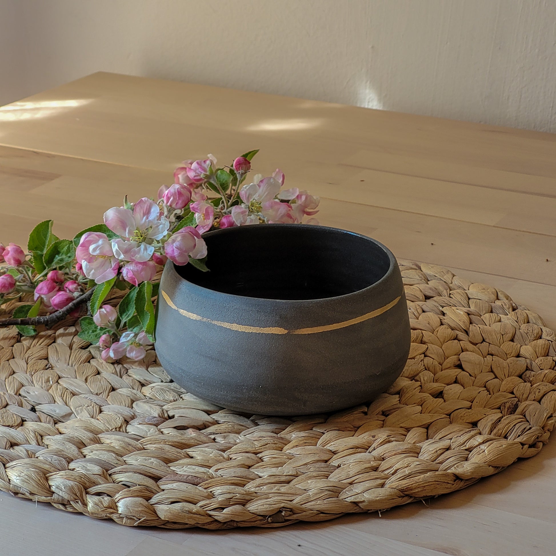 This handmade, pottery, made in ceramic studio Jogita Art Studio gray serving bowl has a gold detail and is the perfect size for all your favorite foods.