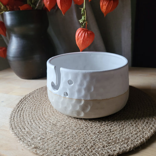 Handmade Ceramic Yarn Bowl - White with Matte Glaze and Textured Design. A functional work of art, this white yarn bowl features a matte glaze and a textured design. Perfect for keeping your yarn organized and tangle-free during your crafting sessions.