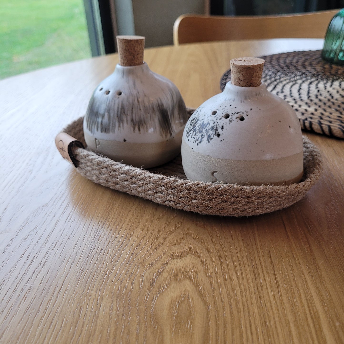 Elegant set of hand-painted salt and pepper shakers in a rustic farmhouse style.