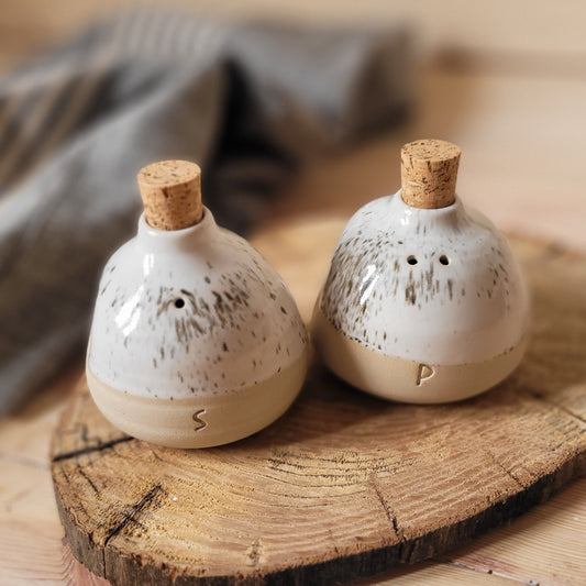 Functional Farmhouse Charm: Salt & pepper shakers in a handmade pottery set.
