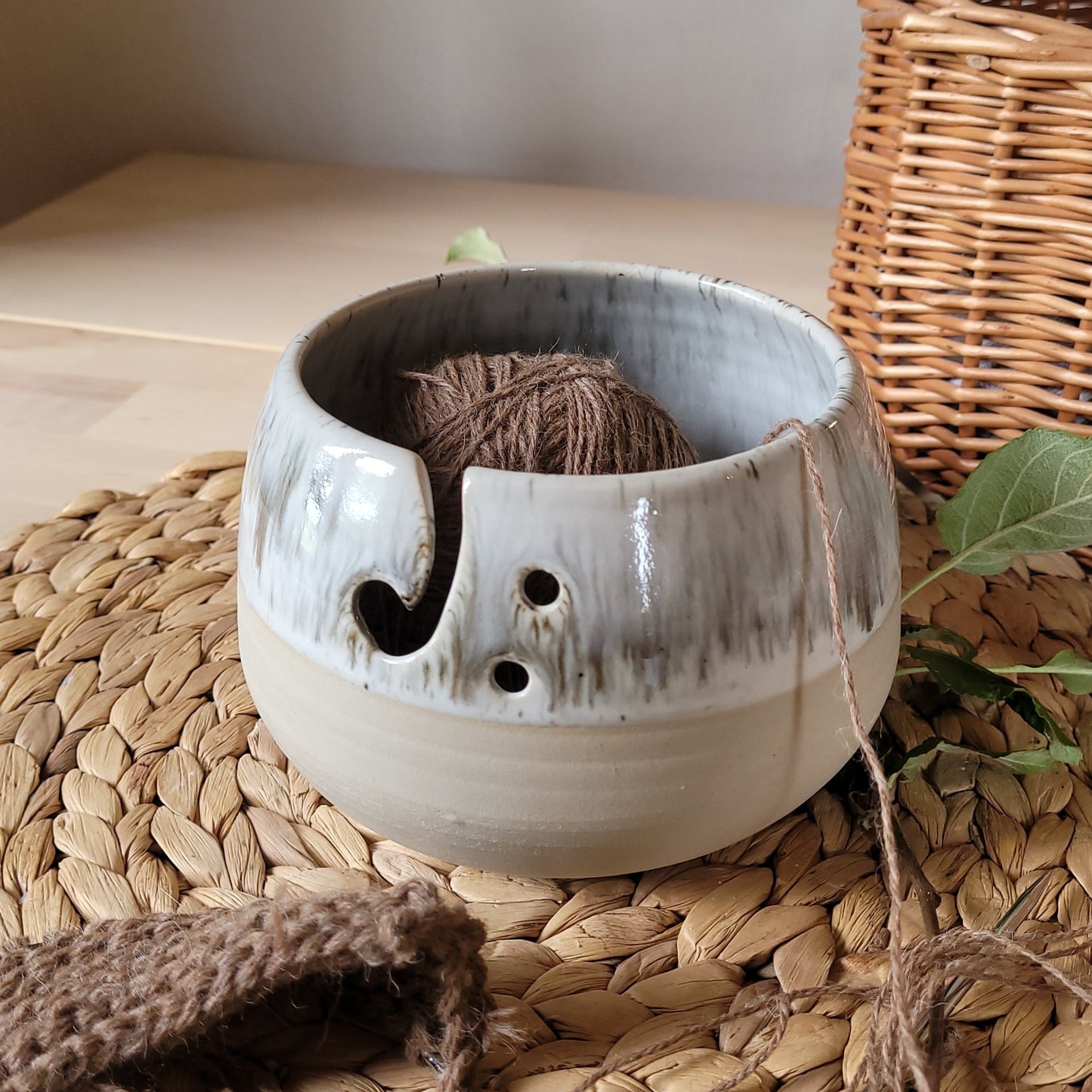 Handcrafted ceramic yarn bowl in a stunning "White+ Creamy Speckled Glaze," perfect for keeping your yarn organized and tangle-free during knitting and crochet sessions.