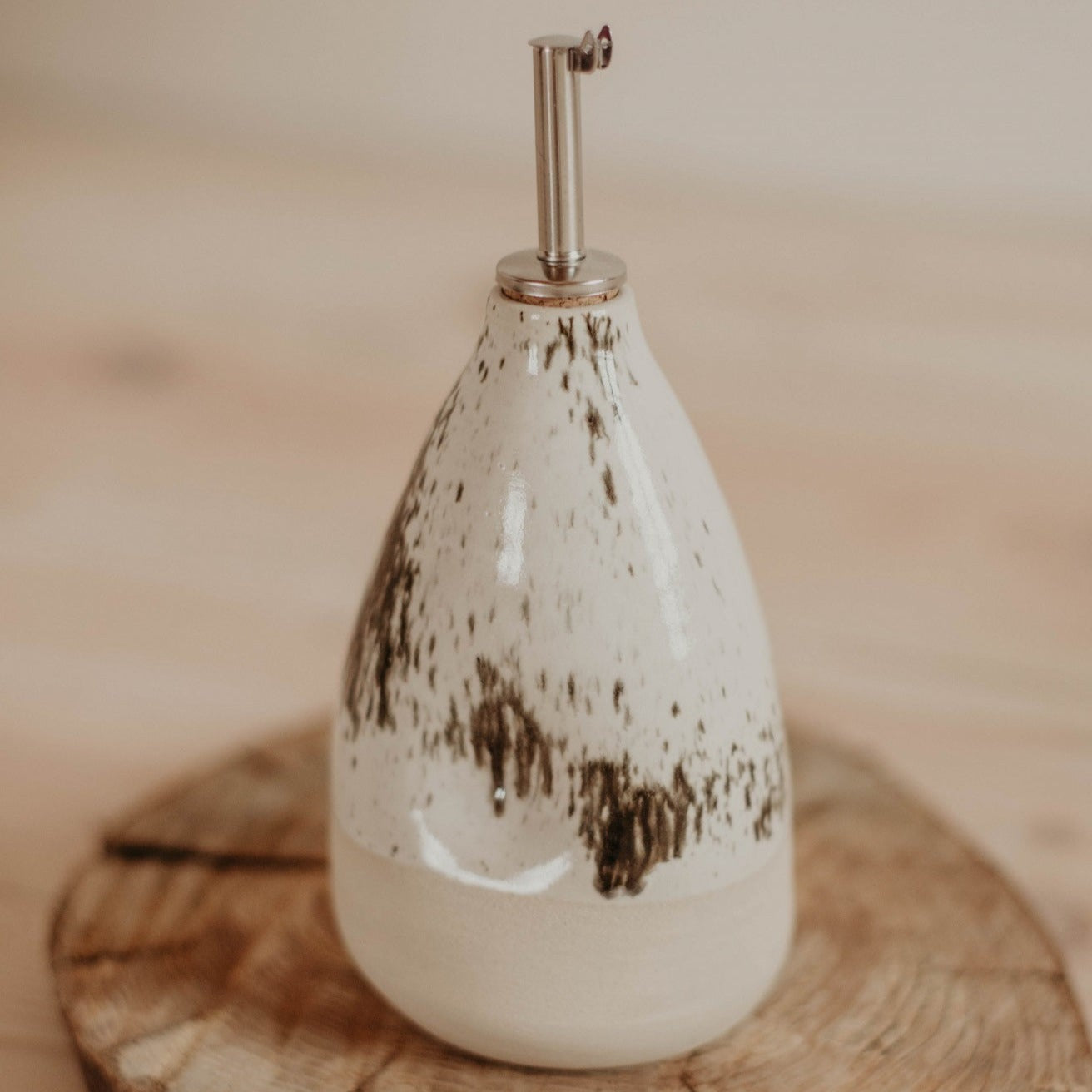 Rustic charm meets modern elegance with this stylish and functional ceramic oil bottle.