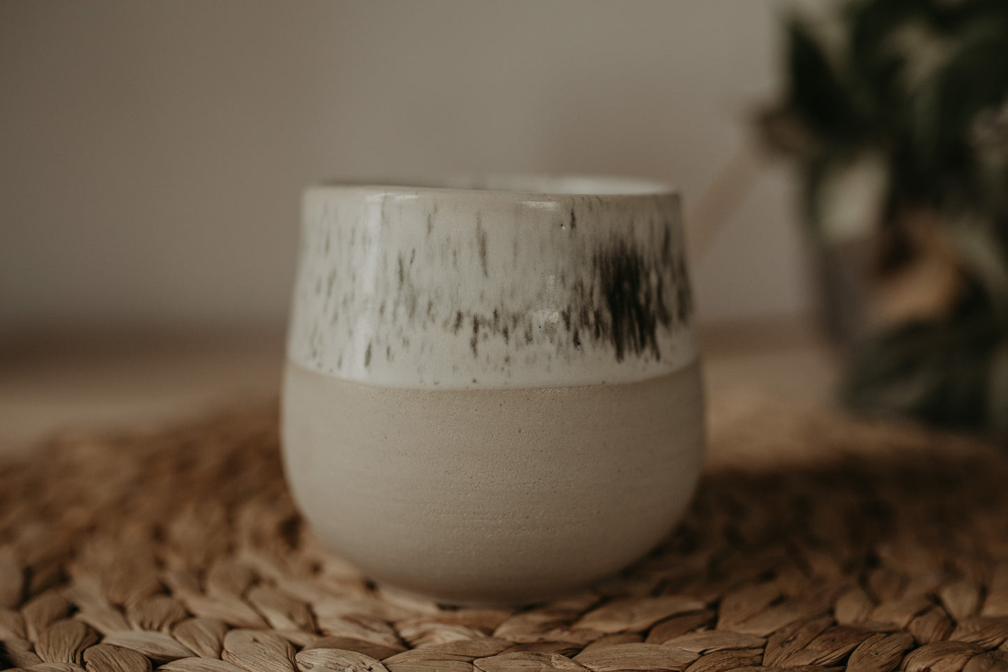 Find elegance and beauty in this handmade, ceramic vase with a white speckled glaze. Add a touch of creativity to your home with this unique pottery.