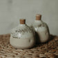 Sustainable pottery shakers in cream color, adorned with S&P stamping, for easy seasoning.