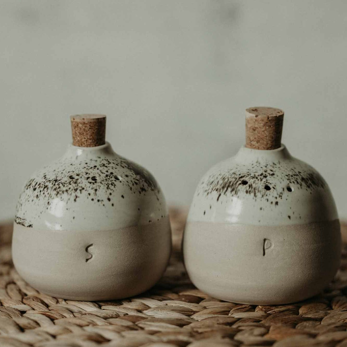 Cream-toned ceramic salt and pepper shakers, handmade with love and attention to detail.