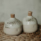 Earthy and practical cream-toned shakers for salt and pepper, exquisitely handcrafted by a one-person pottery studio.