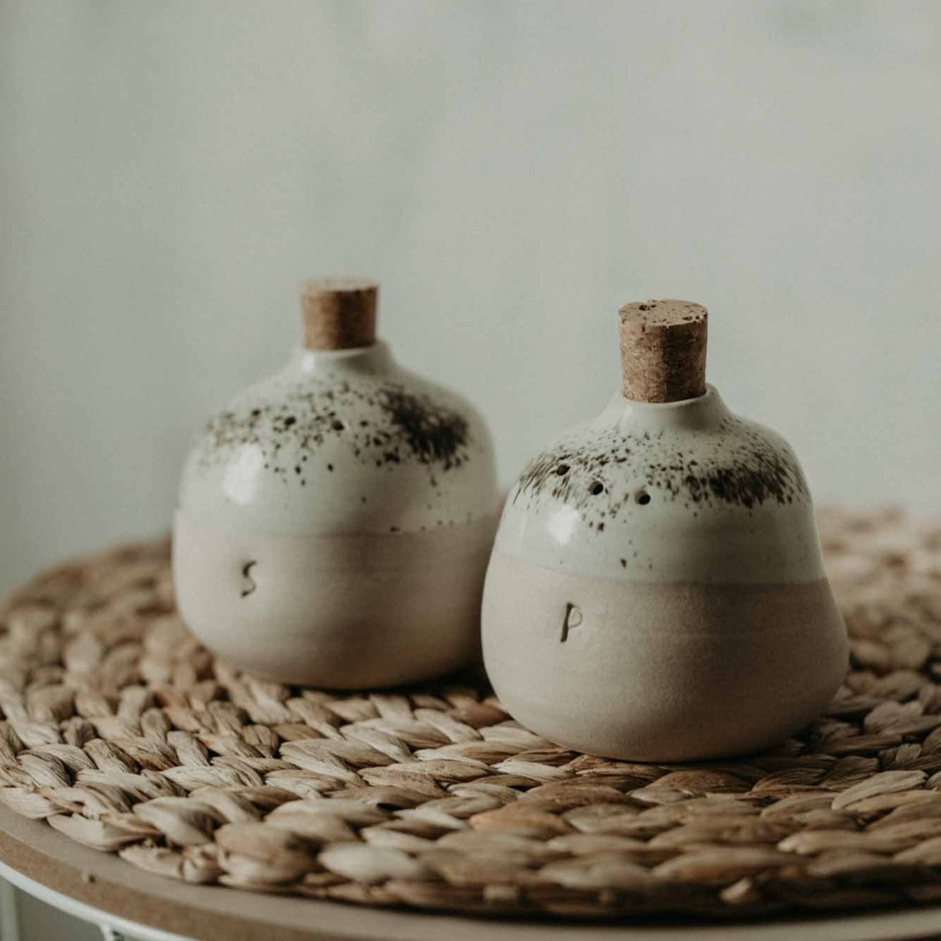 Handmade cream-toned salt and pepper shakers with milk-white glaze and S&P stamping
