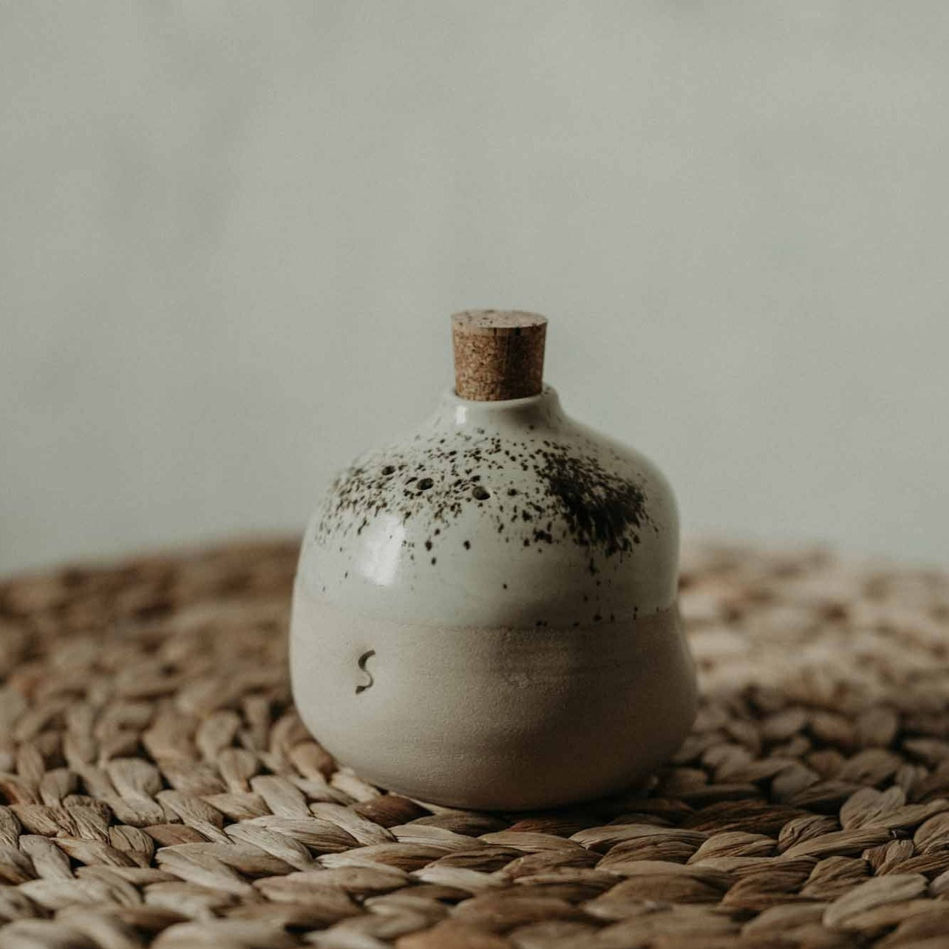 Handmade clay salt and pepper shakers with a milk-white glaze, adding elegance to your kitchen.