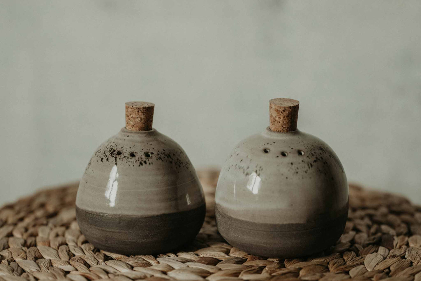 Get a unique and rustic look for your dinnerware with our modern minimalist style ceramic salt & pepper shakers set featuring a gray speckled glaze.